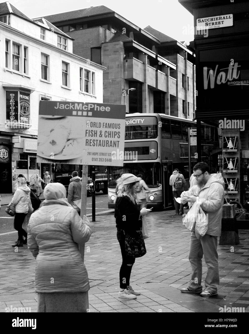 Sandwich board type street advertising fish and  chips placard student minimum wage worker foreigner  Sauchiehall st  pavement Stock Photo