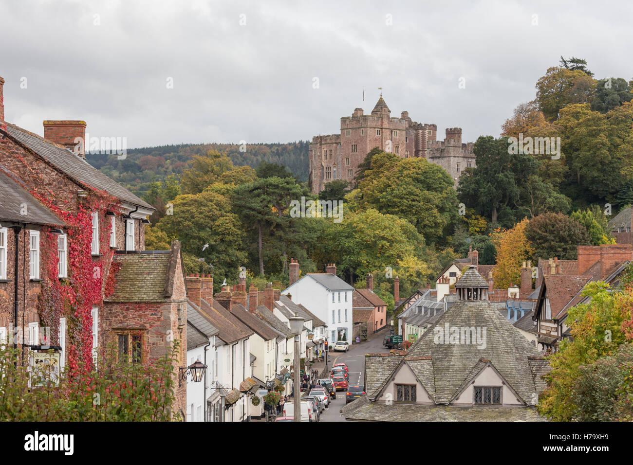 The High Street of Dunster village overlooked by Dunster Castle near