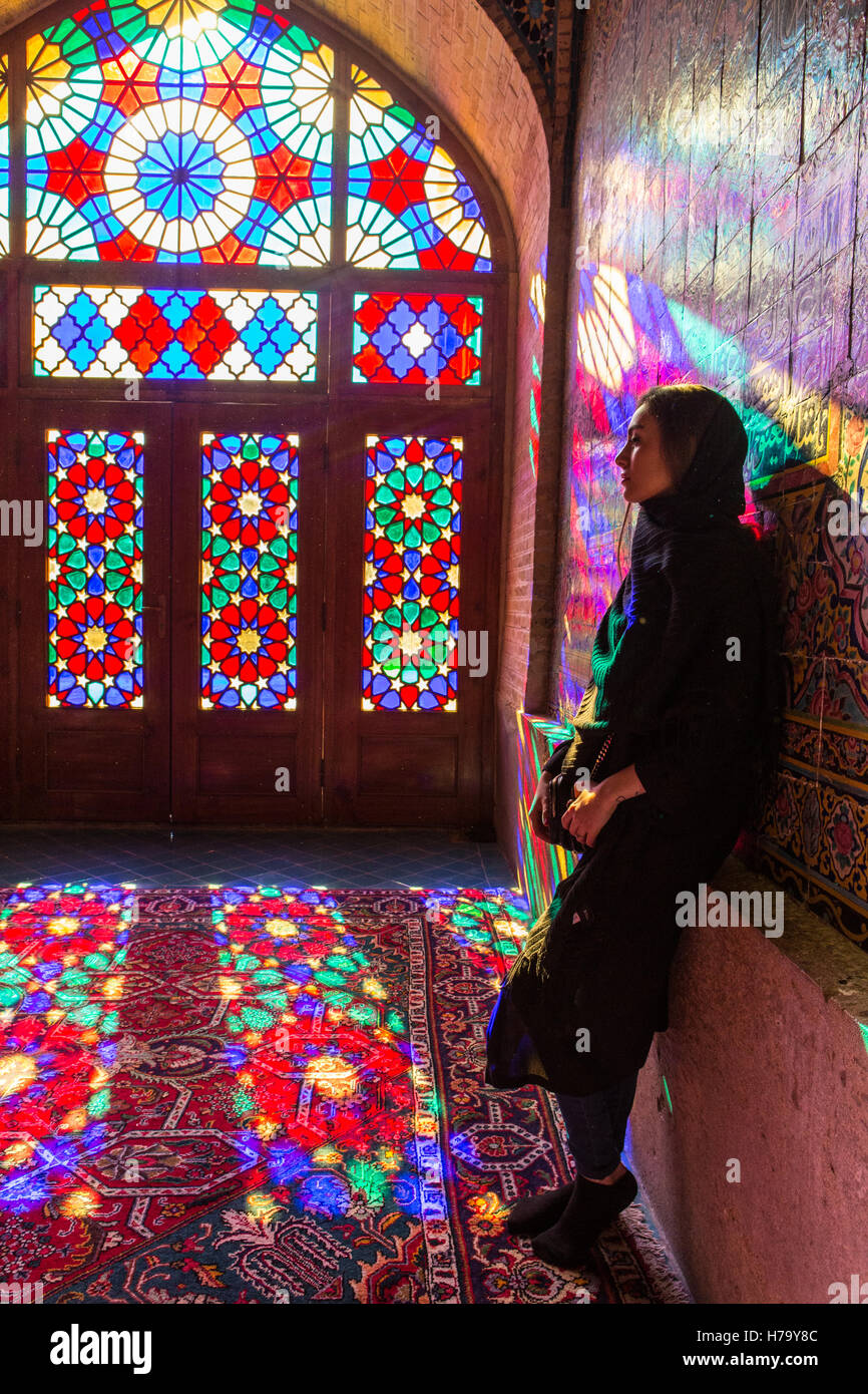 lady standing in the light of a stained glass window Stock Photo Alamy