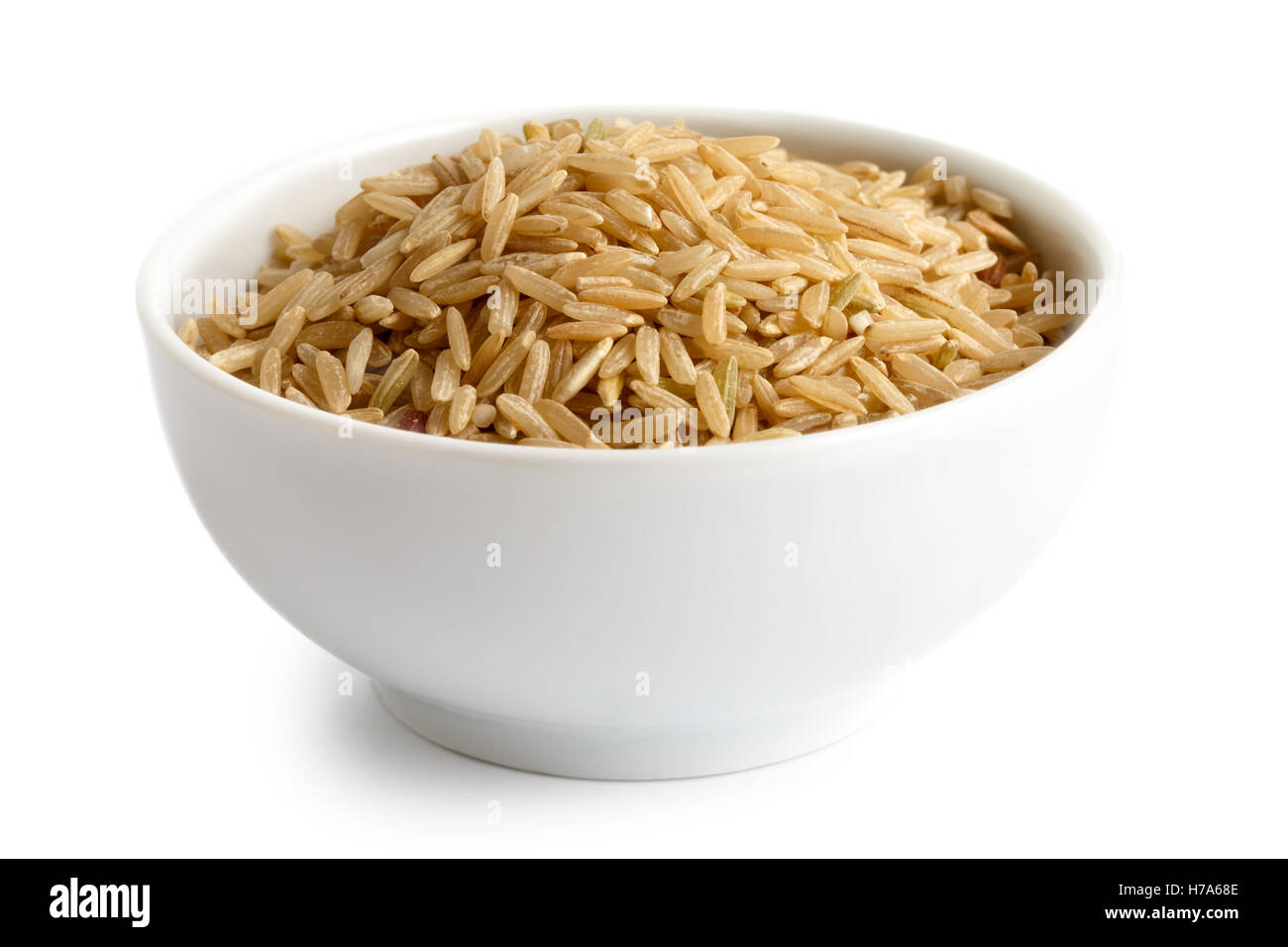 Bowl of long grain brown rice isolated on white. Stock Photo