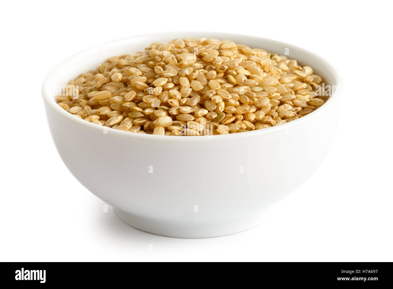 Bowl of short grain brown rice isolated on white. Stock Photo