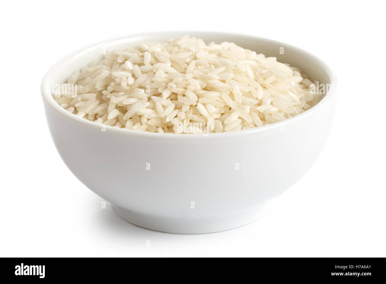 Bowl of long grain white rice isolated on white. Stock Photo