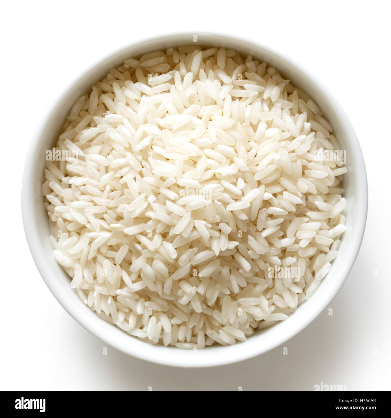 Bowl of long grain white rice isolated on white from above. Stock Photo