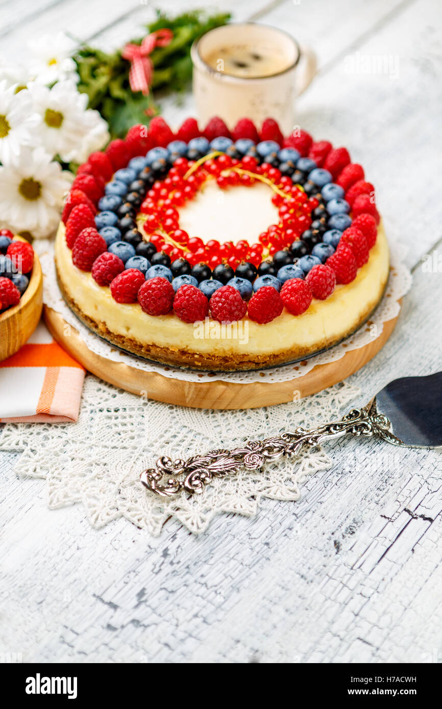 Raspberry and blueberry cheesecake on wooden table Stock Photo