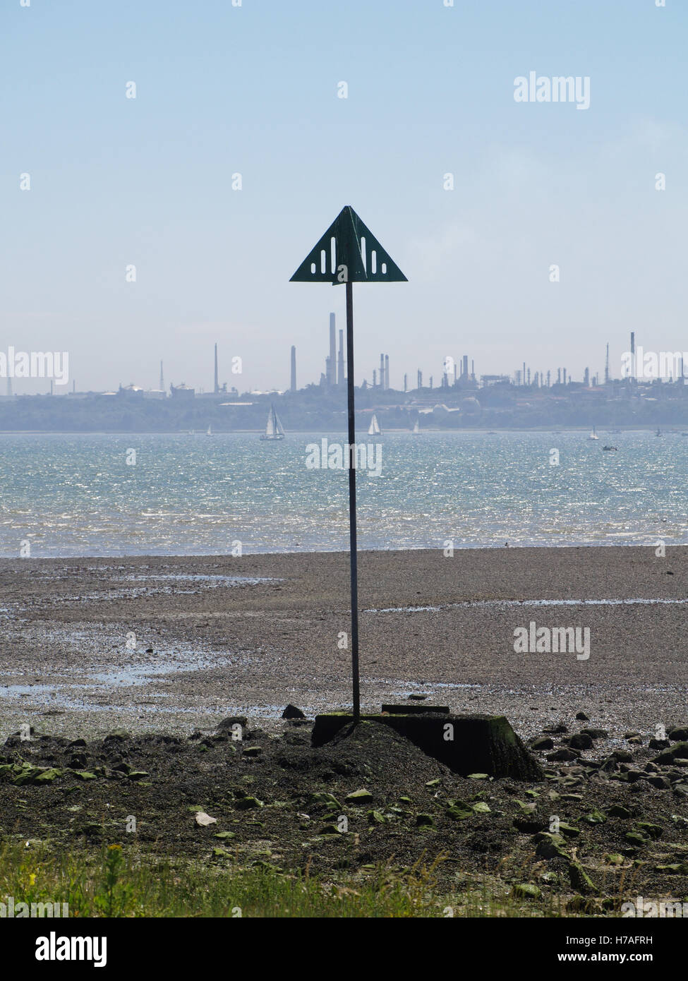 Pipeline marker post at Weston Parade, Woolston, Southampton with Fawley Refinery in distance Stock Photo