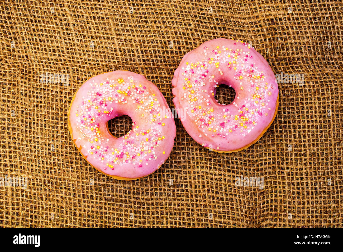 Two sweet donut with pink frosting Stock Photo