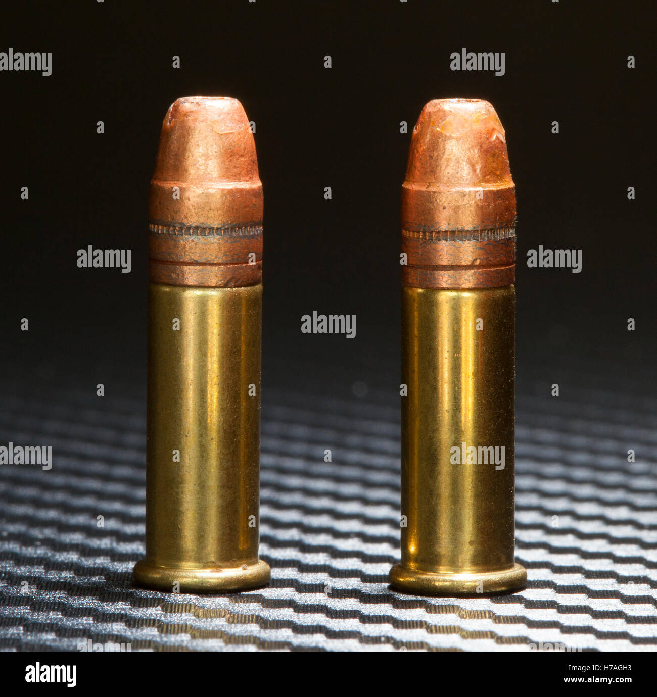 Two cartridges designed for rimfire guns that have copper plated bullets Stock Photo
