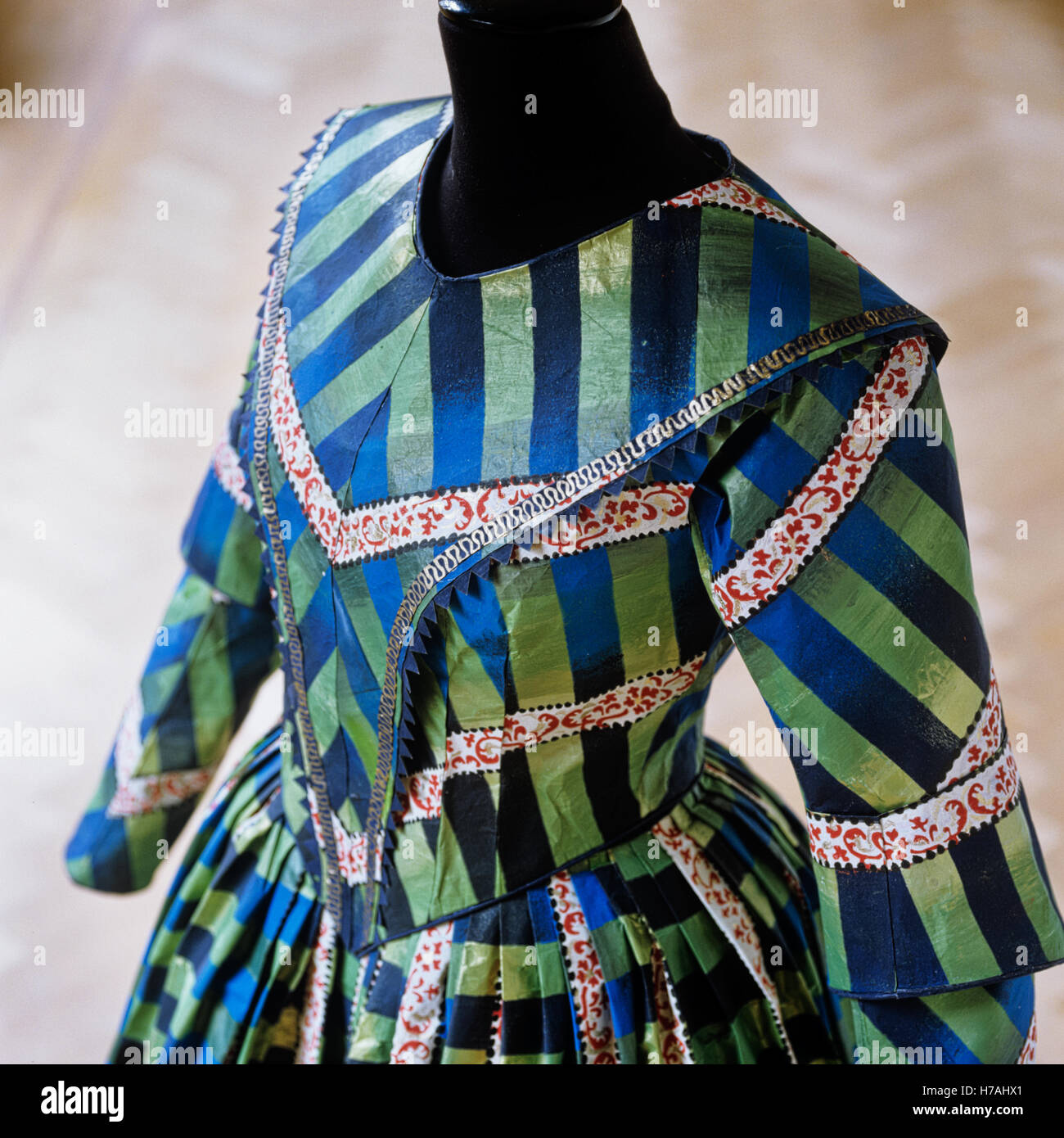 Green and blue striped historical replica paper dress with red foliate detailling, by Isabelle de Borchgrave Stock Photo