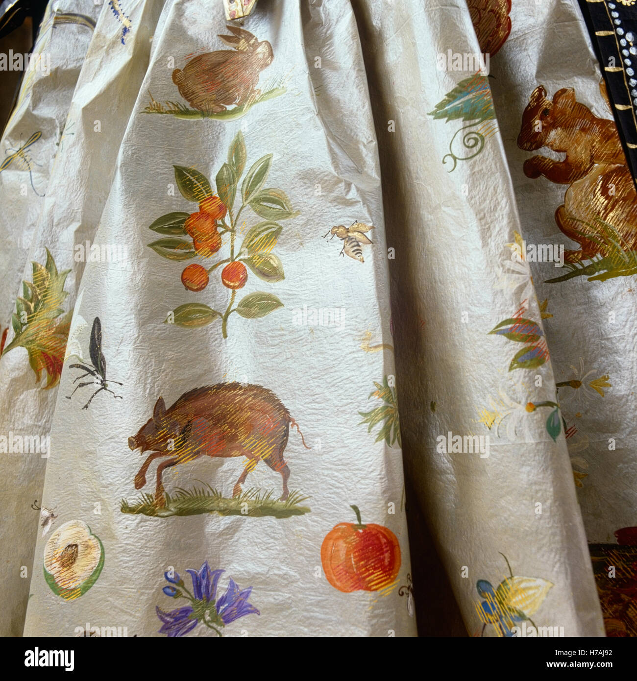 Hand-painted animals and fruit on skirt of historical replica paper dress by Isabelle de Borchgrave Stock Photo