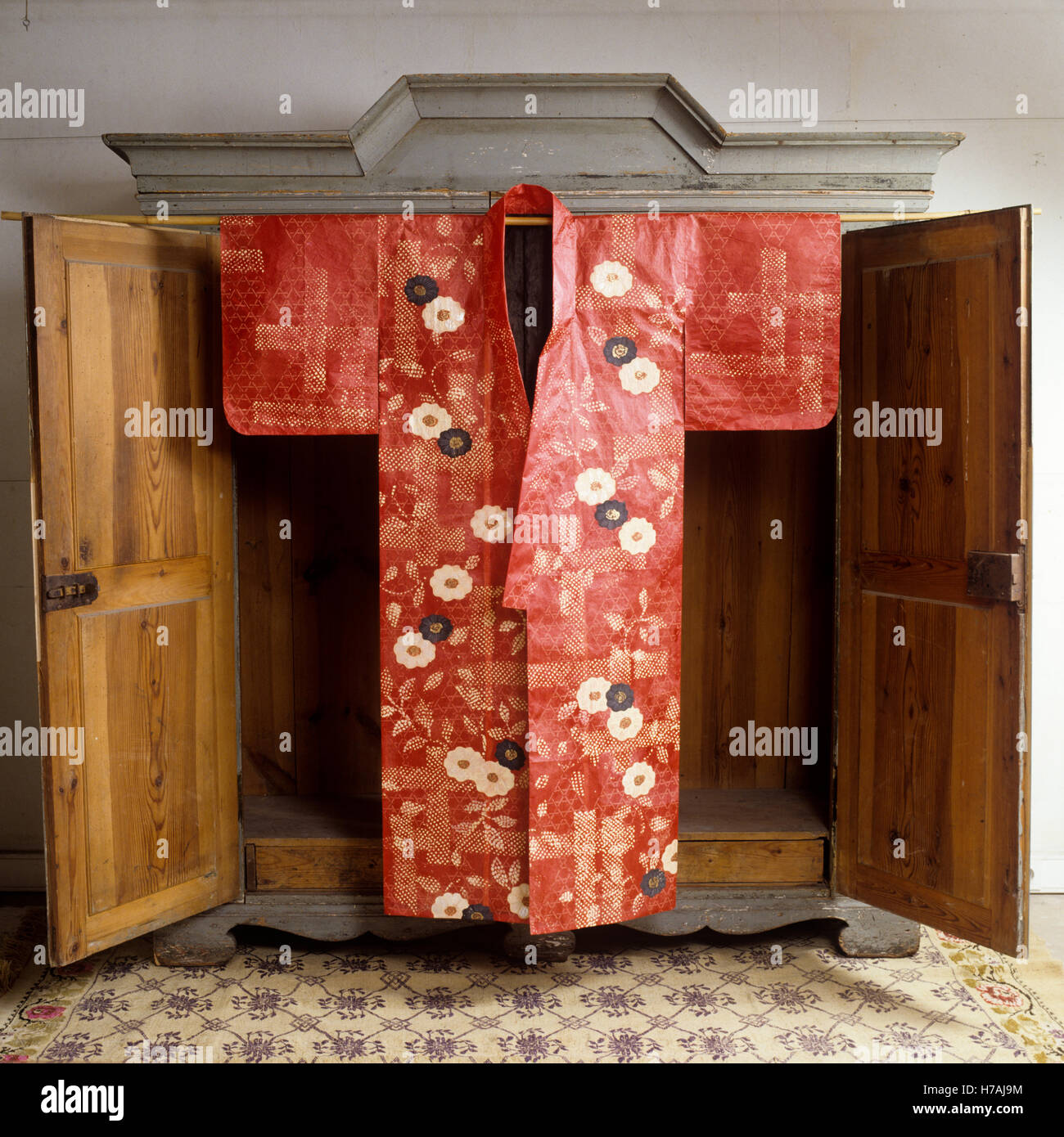 Red floral patterned historical replica paper  kimono by Isabelle de Borchgrave Stock Photo