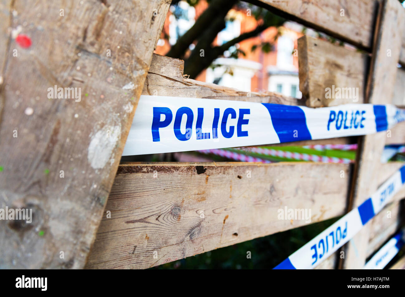Police tape used to let people know police are aware of incident keep out police sign UK England