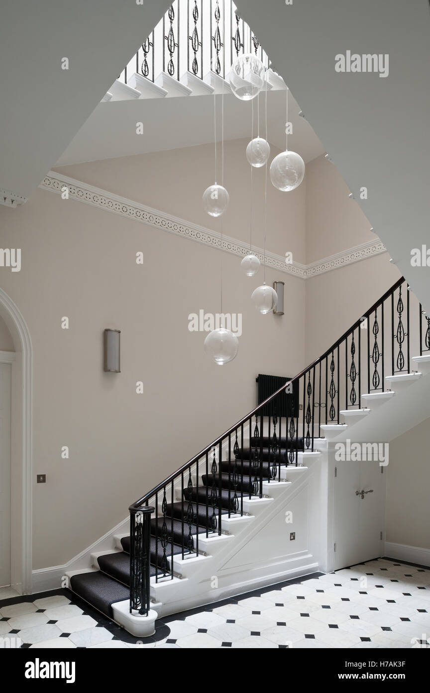 Glass pendant shades suspended above staircase in Gloucester Place interior, London, England, UK Stock Photo