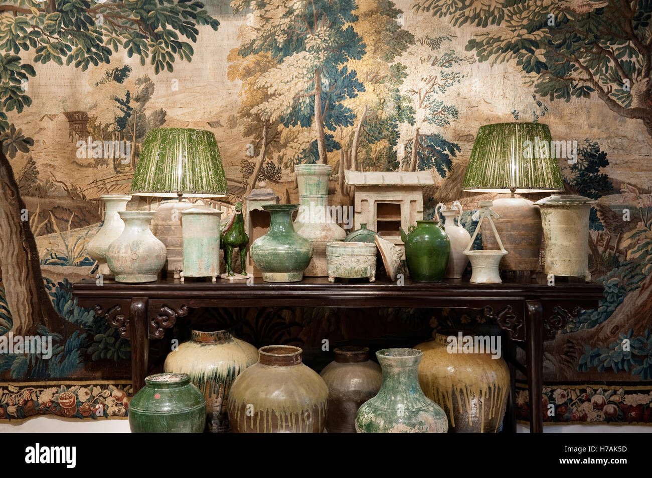 Chinese Han Dynasty green glazed pottery Baluster vases on console table with tapestry backdrop Guinevere's antique shop Stock Photo