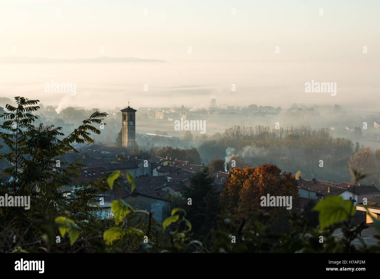 An autumn early morning fog above the town of Burolo di Ivrea in the Canavese area of the Piemonte region of Italy Stock Photo