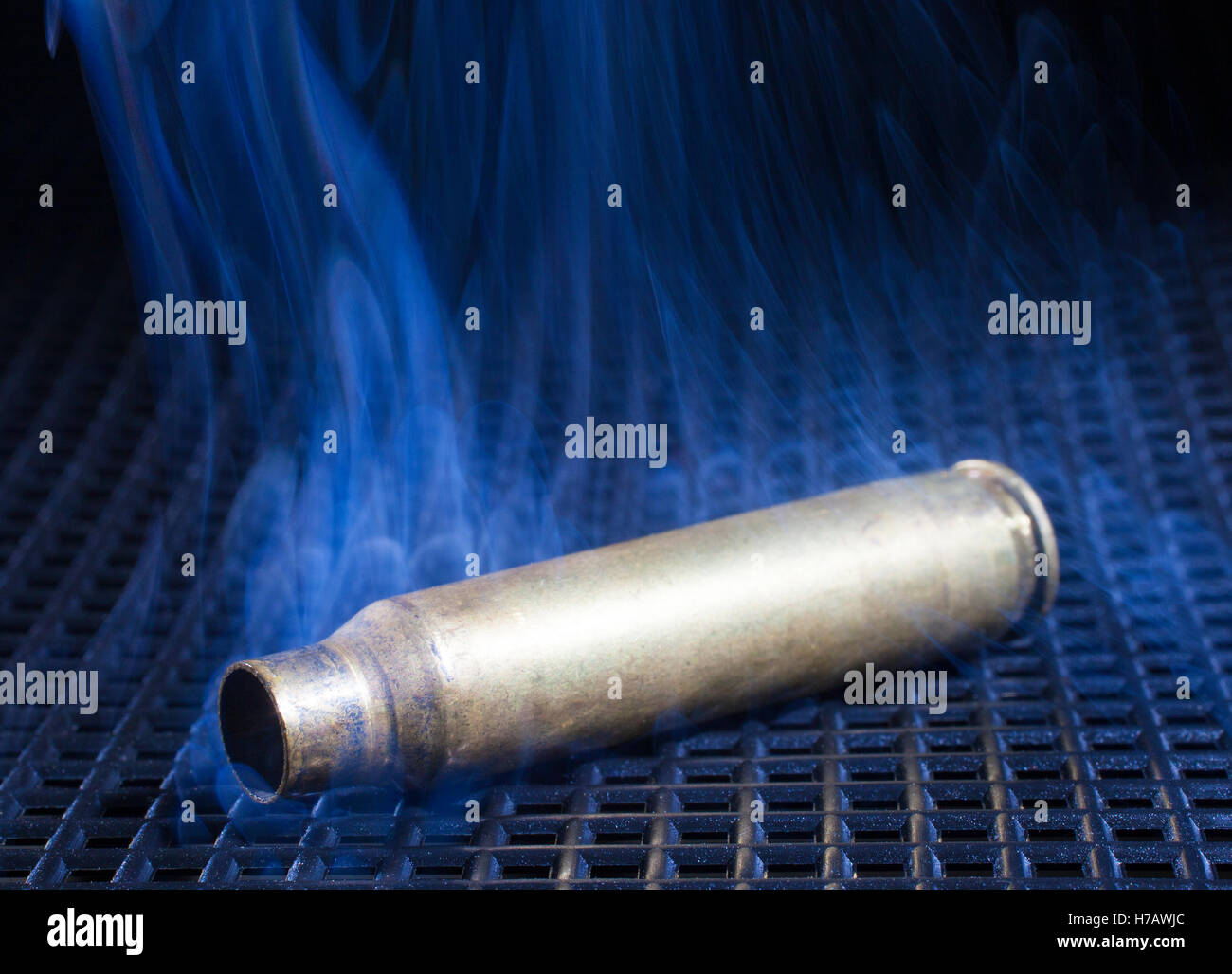 Rifle brass that is empty with smoke all around Stock Photo Alamy