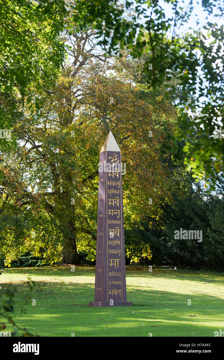 Om and Sanskrit on the peace Obelisk at Waterperry gardens in autumn, Wheatley, Oxfordshire. UK Stock Photo