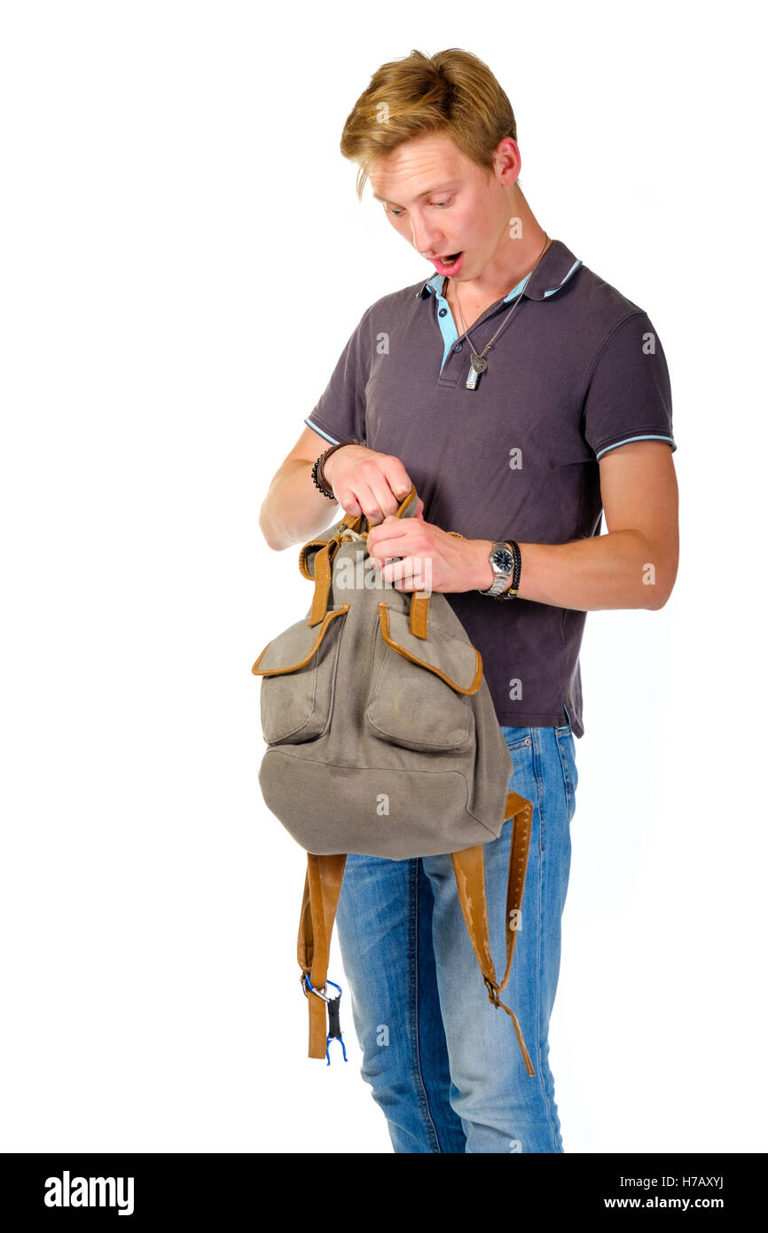Young man looking for something inside his backpack stock photo alamy
