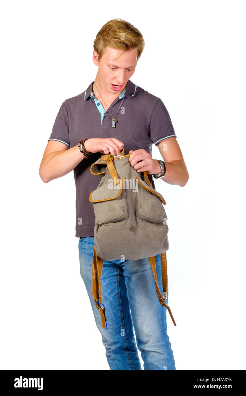 Young man looking for something inside his backpack Stock Photo - Alamy