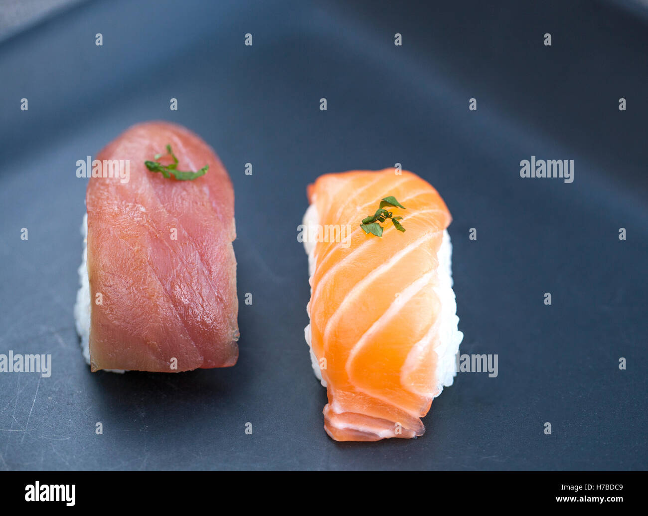 Close-up view of fresh tuna and salmon nigiri on a dark plate Stock Photo