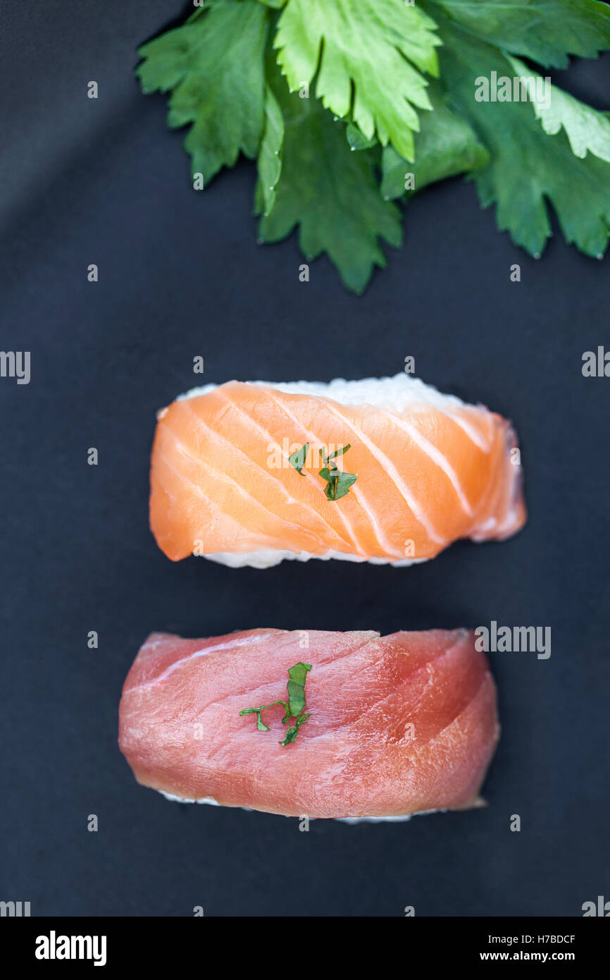 Close-up view of fresh tuna and salmon nigiri on a dark plate Stock Photo