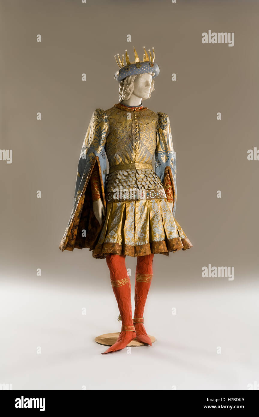 Prince stands in gold jacket and skirt with crown, historical replica made of paper, by Isabelle de Borchgrave Stock Photo