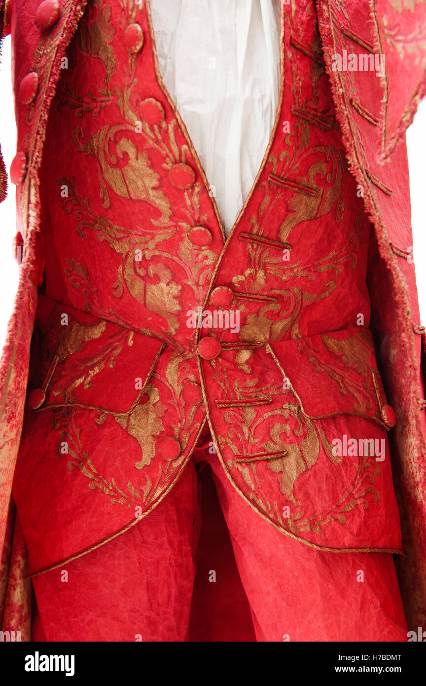 Bright red jacket and trousers with gold foliate pattern, historical replica paper garments, by Isabelle de Borchgrave Stock Photo