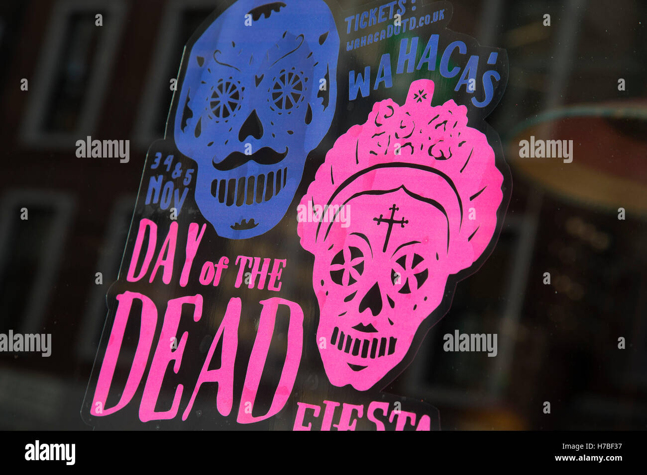 Day of the Dead promotion in a restaurant window following a suspected outbreak of norovirus, several branches of the Wahaca Mexican food chain were closed after over 350 members of the public and staff fell ill of a probable breakout of the winter vomiting bug, including this branch in Great Portland Street in London, United Kingdom. Co-founders Thomasina Miers, and Mark Selby, said: “We assessed each case and when it became clear they were not isolated incidents, we got in touch with relevant officials at Public Health England and environmental health officers.” In all nine branches were sus Stock Photo
