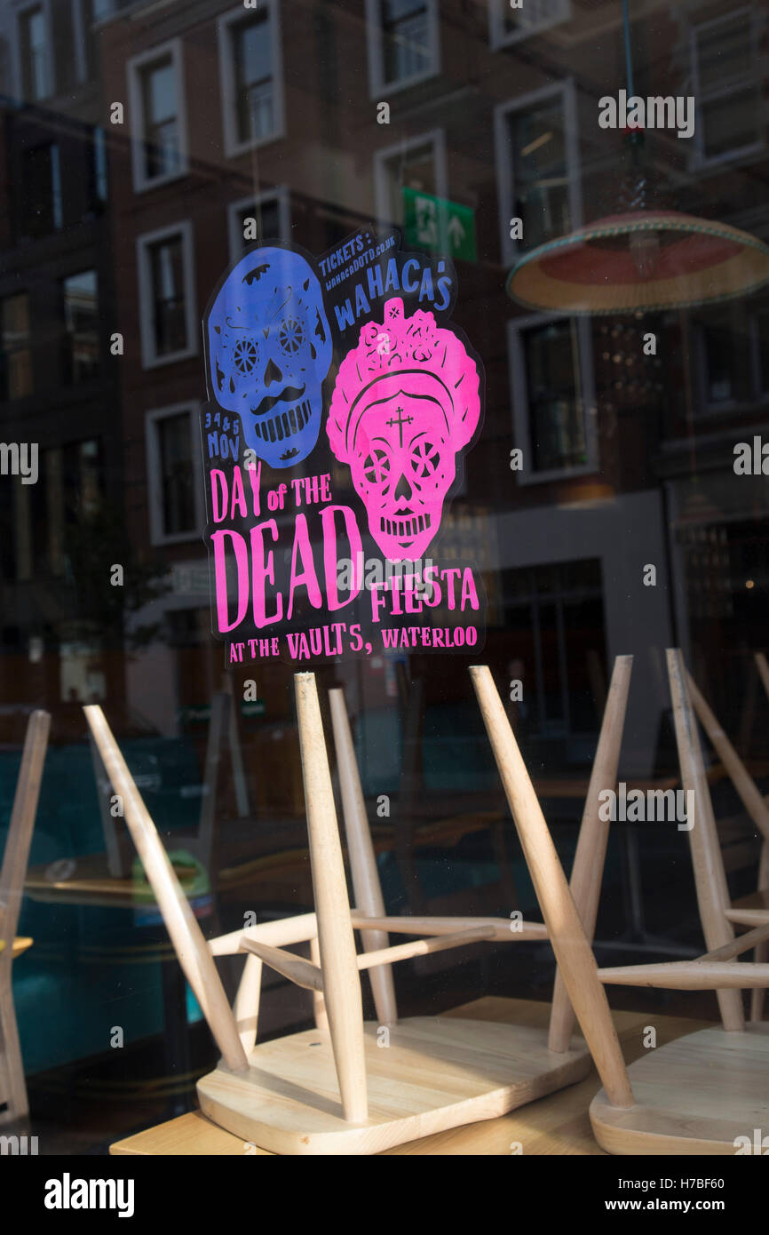 Day of the Dead promotion in a restaurant window following a suspected outbreak of norovirus, several branches of the Wahaca Mexican food chain were closed after over 350 members of the public and staff fell ill of a probable breakout of the winter vomiting bug, including this branch in Great Portland Street in London, United Kingdom. Co-founders Thomasina Miers, and Mark Selby, said: “We assessed each case and when it became clear they were not isolated incidents, we got in touch with relevant officials at Public Health England and environmental health officers.” In all nine branches were sus Stock Photo