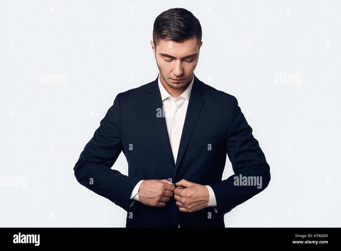 young handsome business man in suit isolated on white background in ...