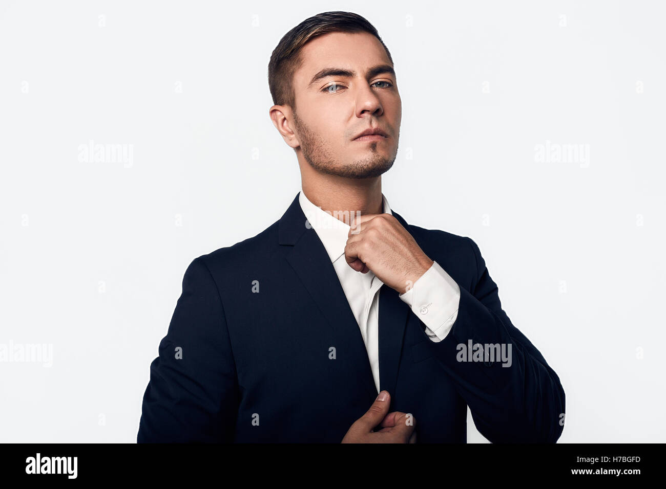 young handsome business man in suit isolated on white background in ...