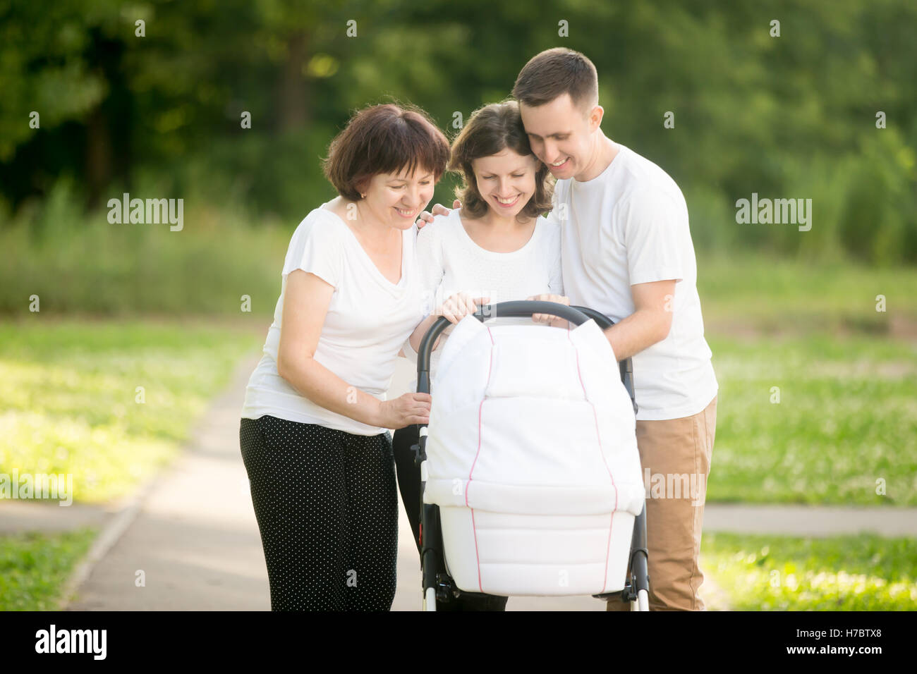 Happy family walking in park Stock Photo - Alamy