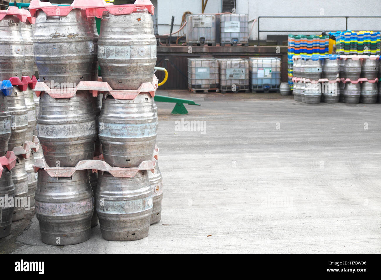 Brewery beer barrels in brewers yard waiting transport to pubs UK Stock
