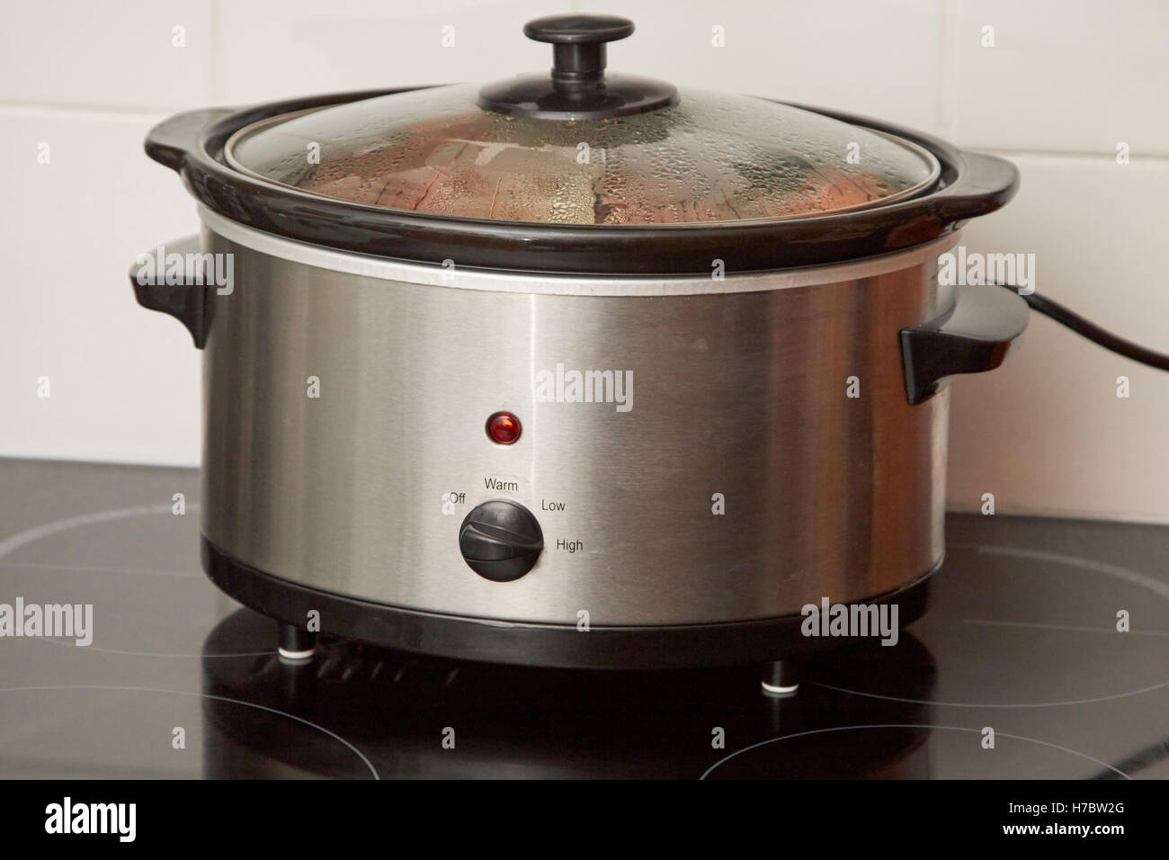 slow cooker cooking a casserole dish in a uk household Stock Photo