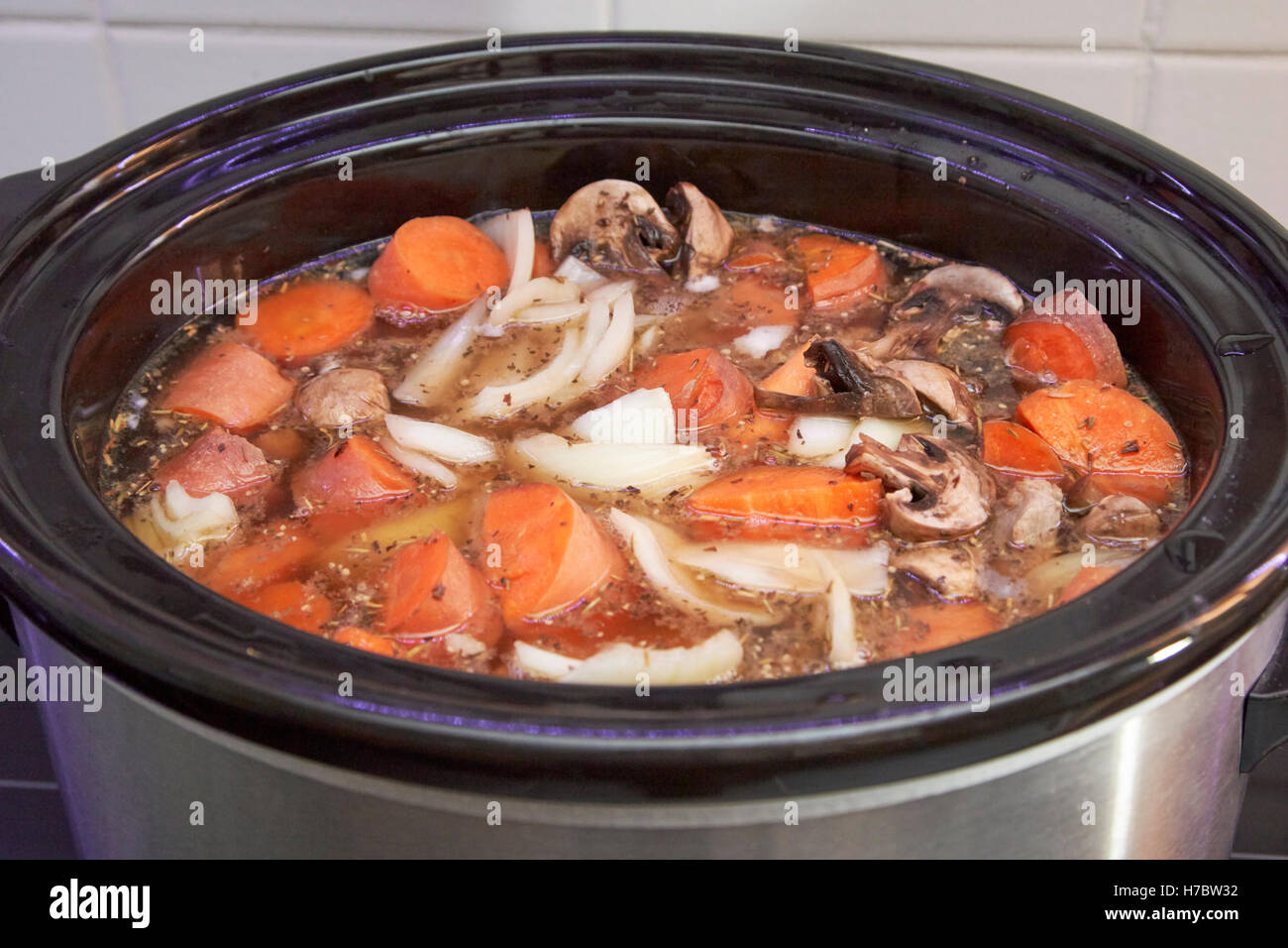 slow cooker cooking a casserole dish in a uk household Stock Photo