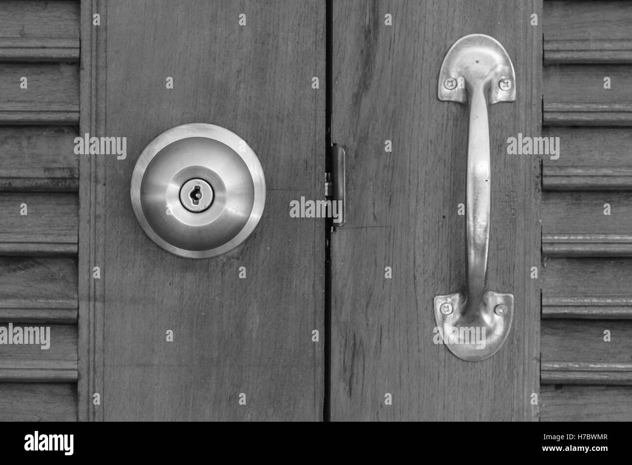 close up of doorknob with wooden door, black and white tone Stock Photo