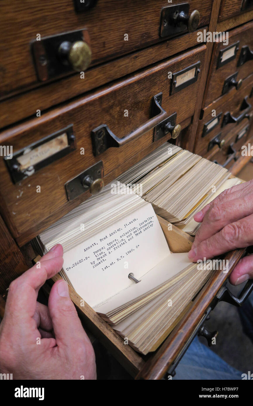 Man Researching Book,  Library Card Catalog, USA Stock Photo