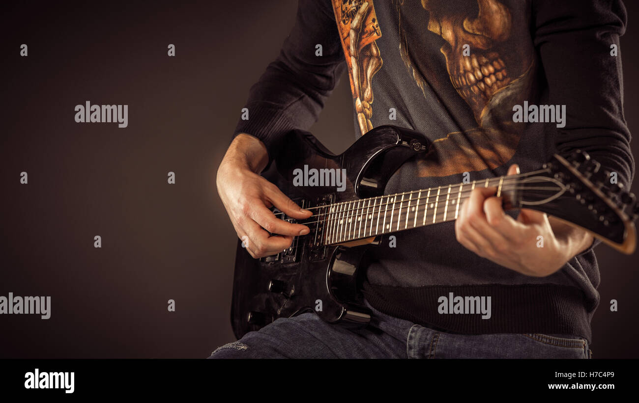 Handsome man playing electro guitar, studio shot Stock Photo