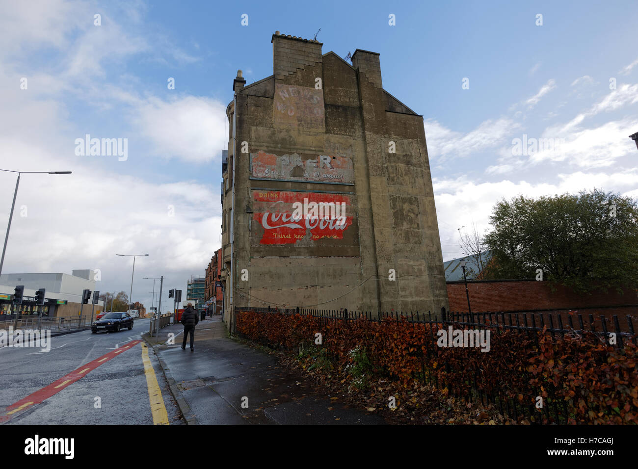 Old vintage advertising signs on the side of tenement building coke  coca cola news of the world and beer Stock Photo