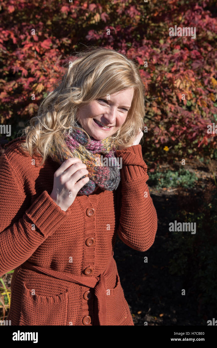 Attractive blond woman in an autumnal park Stock Photo