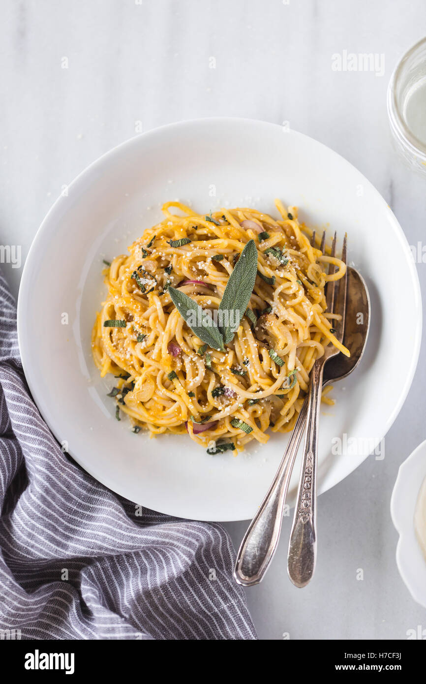 A bowl of Pumpkin Creme fraiche pasta garnished with 2 fresh sage leaves is  photographed from the top view Stock Photo - Alamy