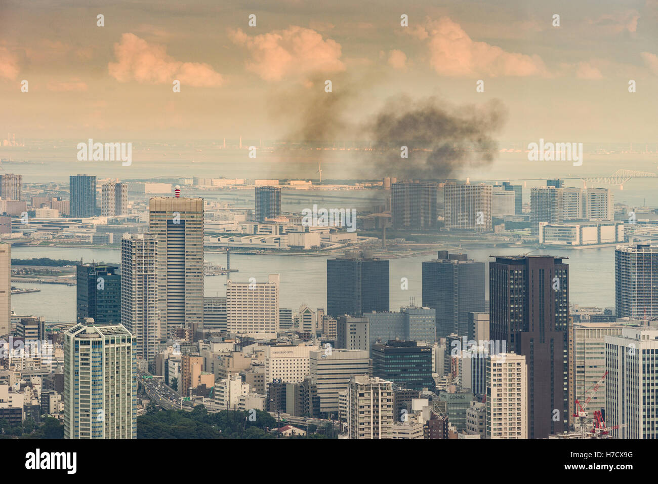 Black smoke wanders over Tokyo harbor. Stock Photo