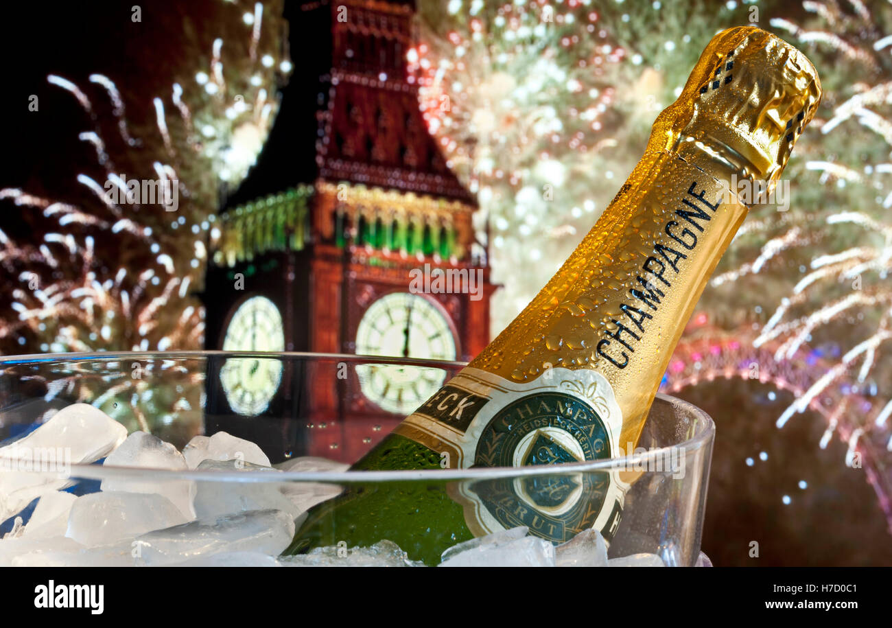 Bottle of champagne on ice in wine cooler with Big Ben and London Eye behind at midnight with big celebration party fireworks Stock Photo