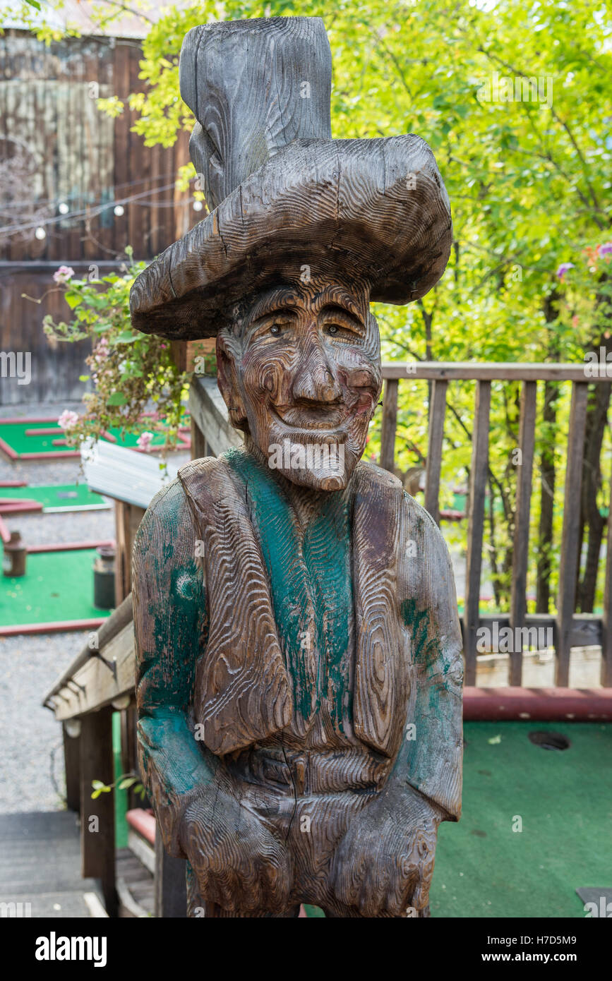 An old wood carved statue of prospector in small western town Winthrop, Washington State, USA. Stock Photo