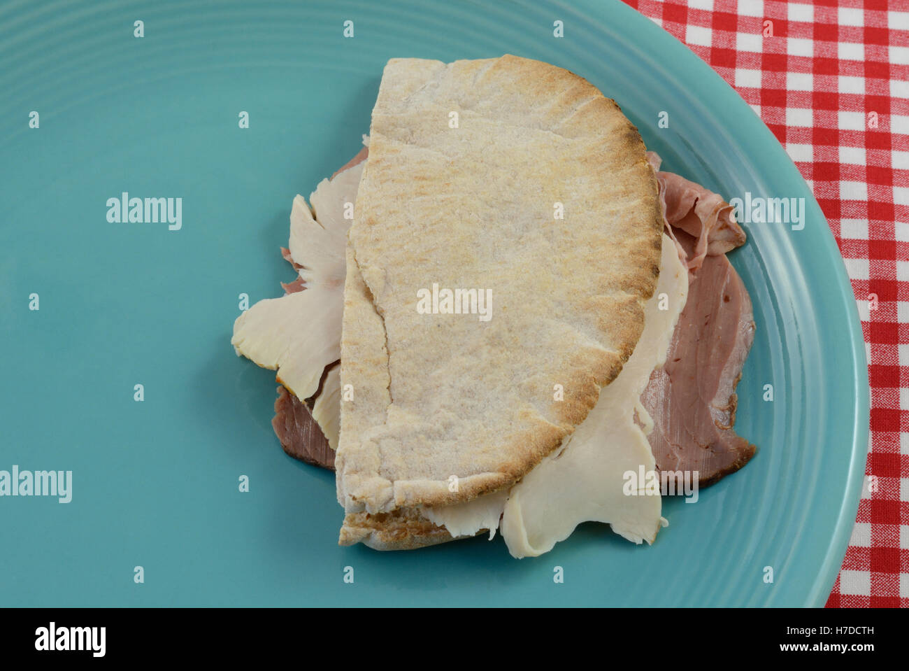 Toasted whole wheat pita bread sandwich with chicken and roast beef