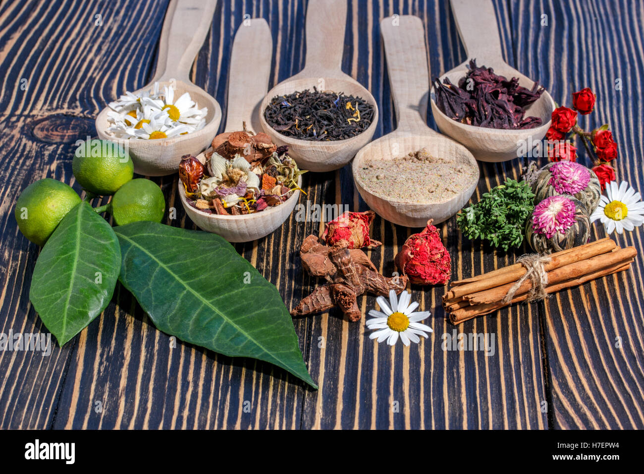 Aromatic flower tea in spoon on rustic background Stock Photo - Alamy
