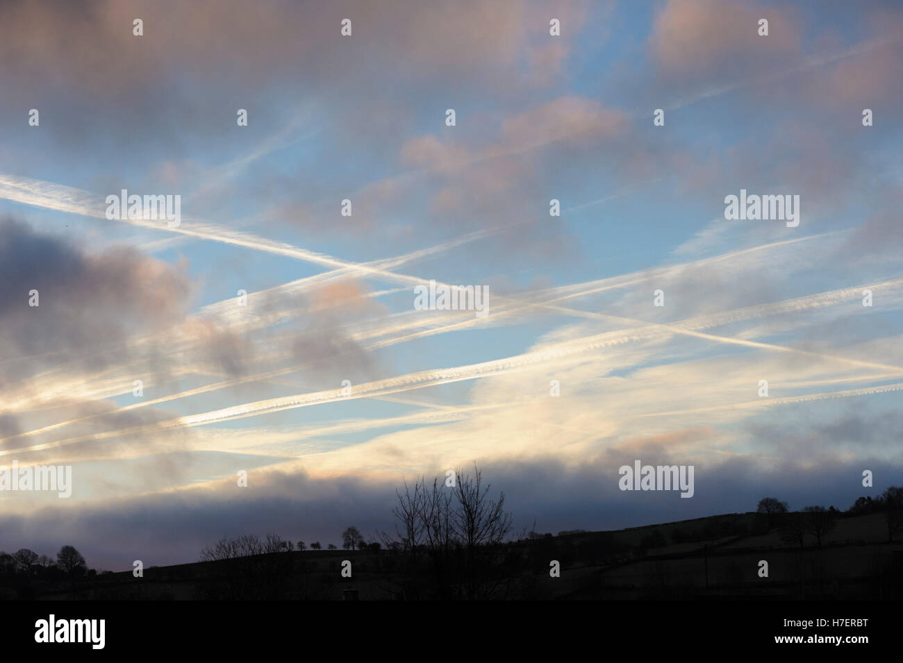 Crossing condensation trails formed by aircraft above the Welsh border Stock Photo