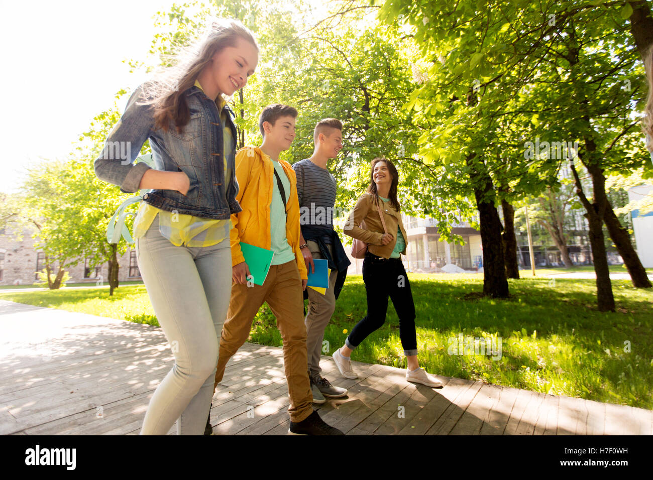 group of happy teenage students walking outdoors Stock Photo - Alamy