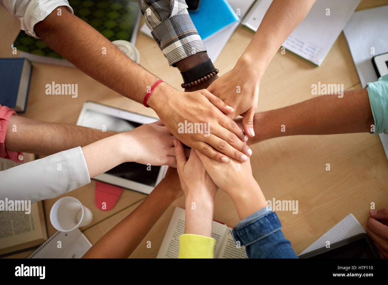group of international students with hands on top Stock Photo - Alamy