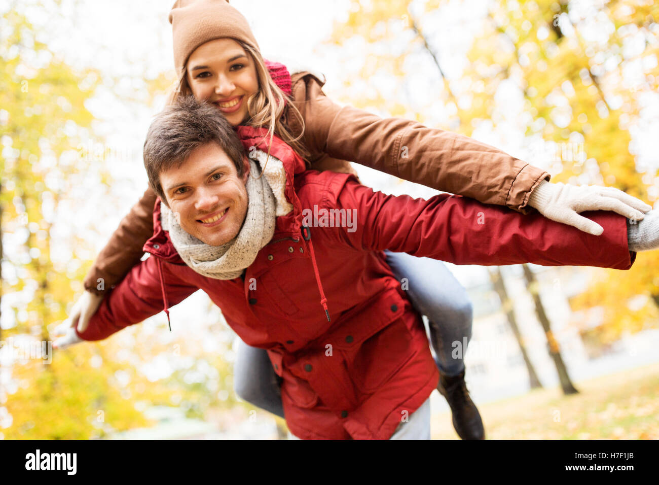 happy young couple having fun in autumn park Stock Photo - Alamy