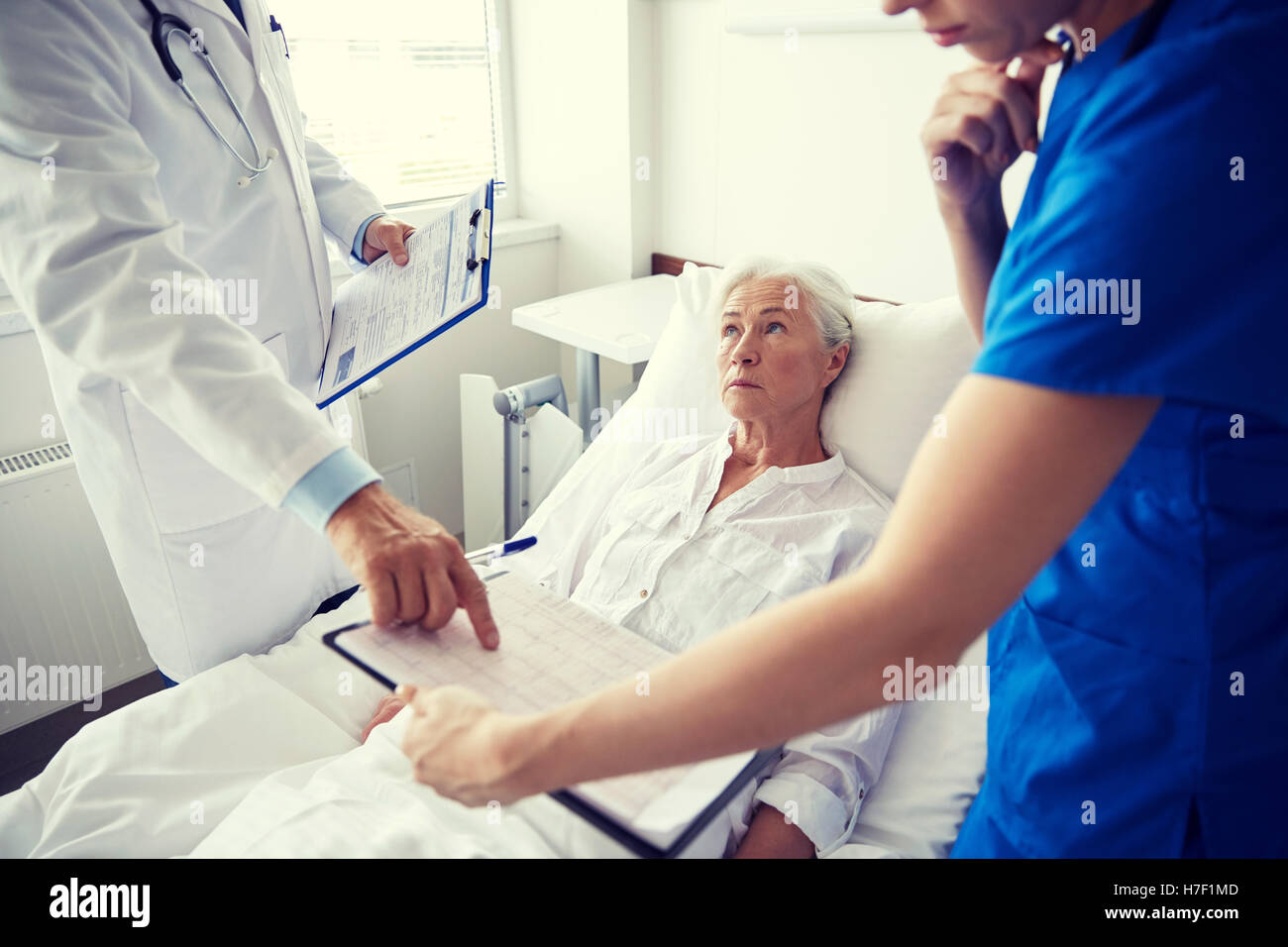 doctor and nurse visiting senior woman at hospital Stock Photo - Alamy